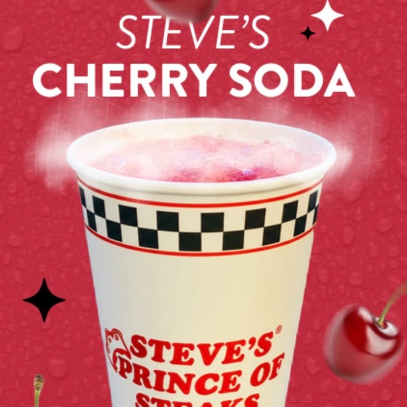 Steve's Cherry Soda in a white cup with a checkered band, against a red background with cherries.